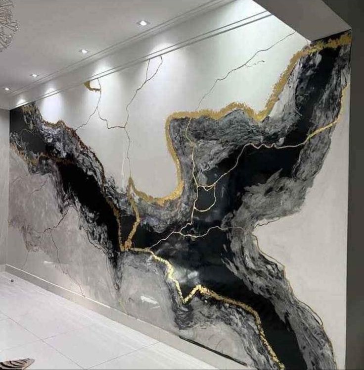 Black and gray marble-look wall with gold veining